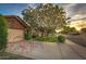A well-manicured front yard of a single-Gathering home with a lush green lawn, mature tree, and a tidy landscape at 4945 E Shapinsay Dr, San Tan Valley, AZ 85140