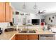 Modern kitchen featuring stainless steel appliances, tile backsplash, and open layout connecting to the living room at 4945 E Shapinsay Dr, San Tan Valley, AZ 85140