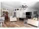 Spacious living room featuring hardwood floors, a ceiling fan, and ample seating for relaxation and entertainment at 4945 E Shapinsay Dr, San Tan Valley, AZ 85140