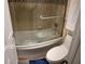 Bathroom featuring a soaking tub with glass doors and a white toilet at 5110 N 31St Way # 345, Phoenix, AZ 85016
