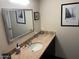 Cozy bathroom featuring a neutral countertop and a decorative mirror at 5110 N 31St Way # 345, Phoenix, AZ 85016