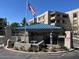 Community entrance with a guard house and an American flag, showcasing a secure and welcoming environment at 5110 N 31St Way # 345, Phoenix, AZ 85016