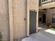 A neutral gray fire door surrounded by textured exterior walls provides secure access at 5110 N 31St Way # 345, Phoenix, AZ 85016