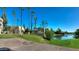 Building exterior with palm trees and a lake view provides a serene tropical vibe at 5110 N 31St Way # 345, Phoenix, AZ 85016