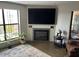 Living room with a modern fireplace, large tv, and comfortable seating area at 5110 N 31St Way # 345, Phoenix, AZ 85016