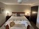 A primary bedroom features a large bed, a bench, and matching side tables with lamps at 5110 N 31St Way # 345, Phoenix, AZ 85016