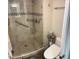 Walk-in shower featuring a glass door, grab bar, shower chair, and modern fixtures at 5110 N 31St Way # 345, Phoenix, AZ 85016