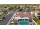 An aerial view shows a home with a backyard pool, hot tub, and covered patio in a residential neighborhood at 5431 W Cochise Dr, Glendale, AZ 85302