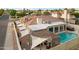 A private backyard featuring a pool, covered patio, and sail shades, perfect for outdoor living at 5431 W Cochise Dr, Glendale, AZ 85302