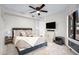 Bright bedroom with a ceiling fan, tiled floors, and a television at 5431 W Cochise Dr, Glendale, AZ 85302