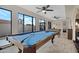 Large game room features a pool table and foosball with big windows at 5431 W Cochise Dr, Glendale, AZ 85302