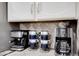 Coffee bar includes countertop espresso machine and coffee maker in this kitchen detail at 5431 W Cochise Dr, Glendale, AZ 85302