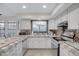 Bright kitchen with white cabinets, stainless steel appliances, and tile countertops at 5431 W Cochise Dr, Glendale, AZ 85302