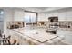 Bright kitchen features white cabinetry, stone countertops, and stainless steel appliances at 5431 W Cochise Dr, Glendale, AZ 85302