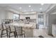 Well-lit kitchen has recessed lighting, tile counters, bar stool seating, and stainless steel appliances at 5431 W Cochise Dr, Glendale, AZ 85302
