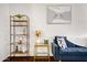 Stylish living room showcasing modern decor, shelving and blue velvet sofa at 5431 W Cochise Dr, Glendale, AZ 85302