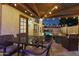 Covered patio with outdoor dining, fire pit, and views of pool and string lights enhance outdoor living at 5431 W Cochise Dr, Glendale, AZ 85302