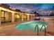 Backyard pool with hot tub, string lights, and large windows, ideal for relaxation and entertainment at 5431 W Cochise Dr, Glendale, AZ 85302