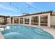 Backyard featuring a refreshing pool with steps, string lights, and a covered patio for entertaining at 5431 W Cochise Dr, Glendale, AZ 85302