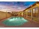 Backyard pool with string lights, outdoor dining, and expansive windows, perfect for relaxation at 5431 W Cochise Dr, Glendale, AZ 85302