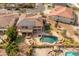 Aerial view of a home, pool, spa, patio and backyard with lush desert landscaping at 5917 N 133Rd Ave, Litchfield Park, AZ 85340