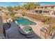 Expansive backyard featuring a pool with waterfall, spa, putting green, and covered patio, ideal for outdoor living at 5917 N 133Rd Ave, Litchfield Park, AZ 85340