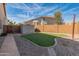 View of backyard with synthetic grass area, storage shed, stone walkways, and block wall fencing at 5917 N 133Rd Ave, Litchfield Park, AZ 85340