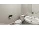 This bathroom features a toilet, sink, and mirror at 5917 N 133Rd Ave, Litchfield Park, AZ 85340