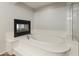 Elegant bathroom featuring modern tub with integrated fireplace at 5917 N 133Rd Ave, Litchfield Park, AZ 85340