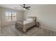 This bedroom boasts natural light, carpet, and a ceiling fan at 5917 N 133Rd Ave, Litchfield Park, AZ 85340