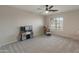 This bedroom features a play kitchen, chair, and ceiling fan at 5917 N 133Rd Ave, Litchfield Park, AZ 85340