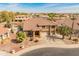 Inviting home with a tile roof, lush landscaping, mature palms, and a three-car garage at 5917 N 133Rd Ave, Litchfield Park, AZ 85340