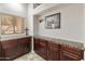 Hallway featuring dark wood cabinetry, granite countertop, and ample storage space at 5917 N 133Rd Ave, Litchfield Park, AZ 85340
