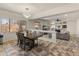 Open-concept living area featuring a dining area, modern light fixture, and a view to the Gathering room at 5917 N 133Rd Ave, Litchfield Park, AZ 85340