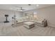 Spacious living room with plush carpet, large sectional sofa, and modern ceiling fan at 5917 N 133Rd Ave, Litchfield Park, AZ 85340