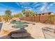 Backyard featuring a stunning pool with waterfall, hot tub and lush landscaping, perfect for relaxing and entertaining at 5917 N 133Rd Ave, Litchfield Park, AZ 85340