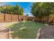 Well-maintained putting green surrounded by lush landscaping, creating a serene and private outdoor recreational space at 5917 N 133Rd Ave, Litchfield Park, AZ 85340