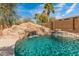 Beautiful backyard pool with rock waterfall, slide, and landscaping, perfect for relaxing and entertaining at 5917 N 133Rd Ave, Litchfield Park, AZ 85340
