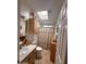 Bright bathroom featuring a skylight, tiled floor, and shower over tub at 650 N Hawes Rd # 4609, Mesa, AZ 85207