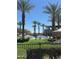 Relaxing community pool surrounded by palm trees, lounge chairs, and cabanas, perfect for enjoying sunny days at 650 N Hawes Rd # 4609, Mesa, AZ 85207