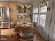 Bright dining area with a round table set for four, surrounded by natural light and attractive cabinetry at 650 N Hawes Rd # 4609, Mesa, AZ 85207