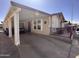 Exterior of home featuring a long driveway, carport, and covered patio with railing at 650 N Hawes Rd # 4609, Mesa, AZ 85207
