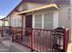 Inviting front porch with a red metal railing, a neutral tan exterior, and awning over the front door at 650 N Hawes Rd # 4609, Mesa, AZ 85207
