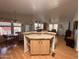 Open-concept living area featuring a kitchen island with cabinets and a dining table in front of a window at 650 N Hawes Rd # 4609, Mesa, AZ 85207