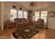 Cozy living room with a ceiling fan, matching sofa and chair, and a rug with southwest patterns at 650 N Hawes Rd # 4609, Mesa, AZ 85207