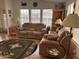 Comfortable living room featuring a sofa, arm chair, wood laminate flooring, and southwest design rug at 650 N Hawes Rd # 4609, Mesa, AZ 85207