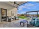 Inviting back patio with comfortable seating, a ceiling fan, and a fire pit area for outdoor relaxation at 6790 S Springs Pl, Chandler, AZ 85249