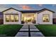 A luxury home featuring a manicured lawn and covered patio with sliding glass doors for seamless indoor-outdoor living at 6790 S Springs Pl, Chandler, AZ 85249