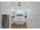 Elegant bathroom with a freestanding tub, shiplap walls, and a large window at 6790 S Springs Pl, Chandler, AZ 85249