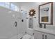 Bathroom featuring an all-glass shower, modern vanity, and sunflower-shaped mirror at 6790 S Springs Pl, Chandler, AZ 85249